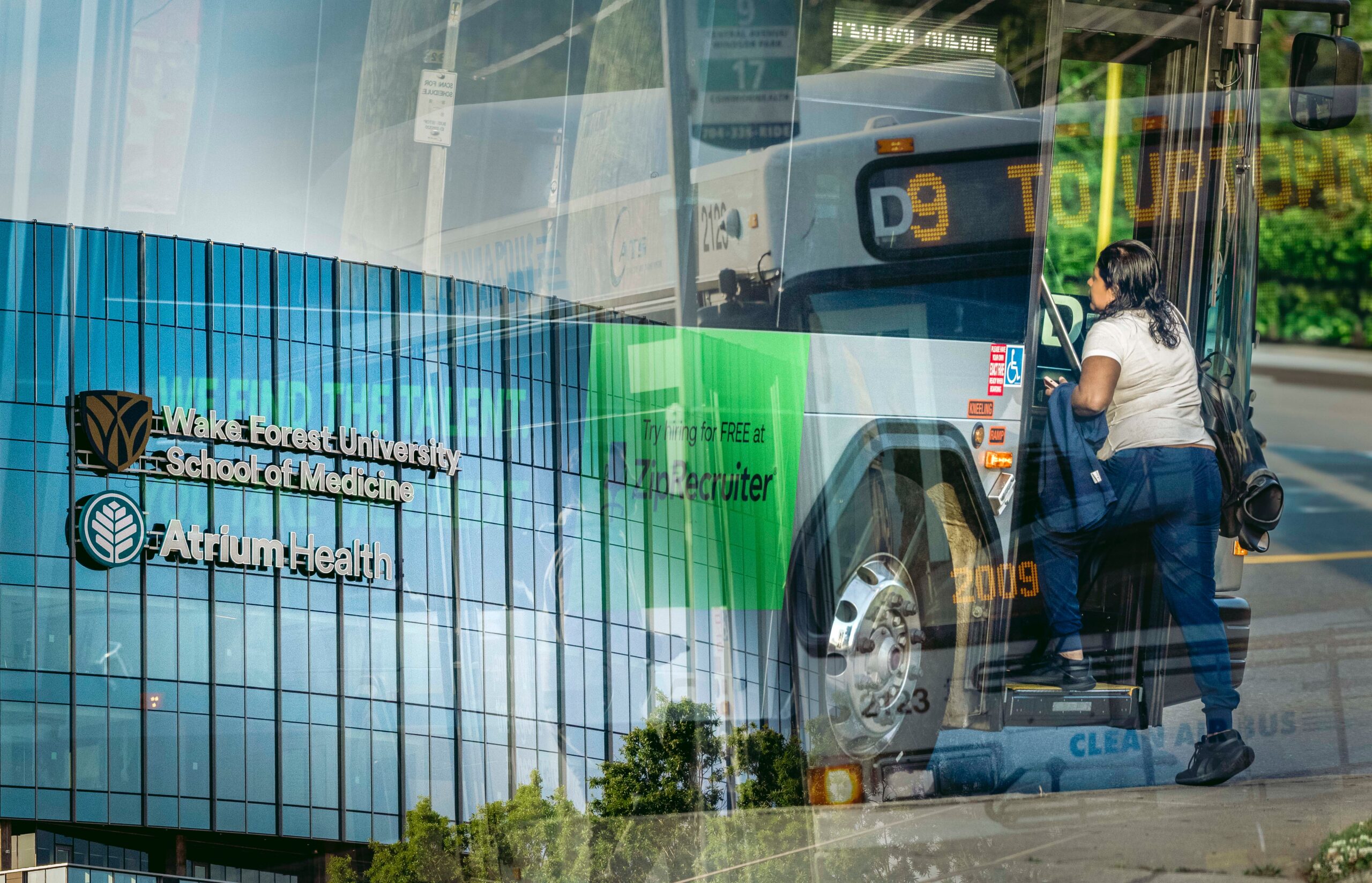 Double exposure picture with two images -- one of a new medical school and research campus, another of a person getting on a bus