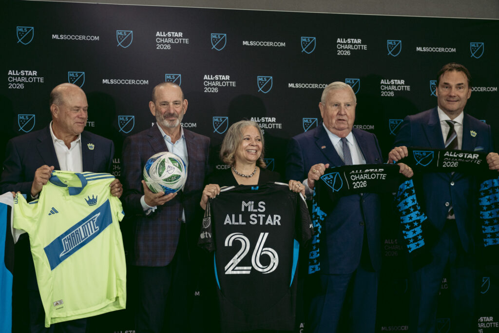 Charlotte Mayor Vi Lyles holds a soccer jersey at the announcement that Charlotte would host the MLS All-Star Game. She's with Charlotte FC owner David Tepper, MLS Commissioner Don Garber, developer Johnny Harris.