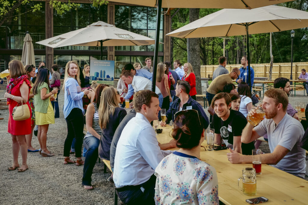 Instabeerup gathering with people sitting around a table drinking beer