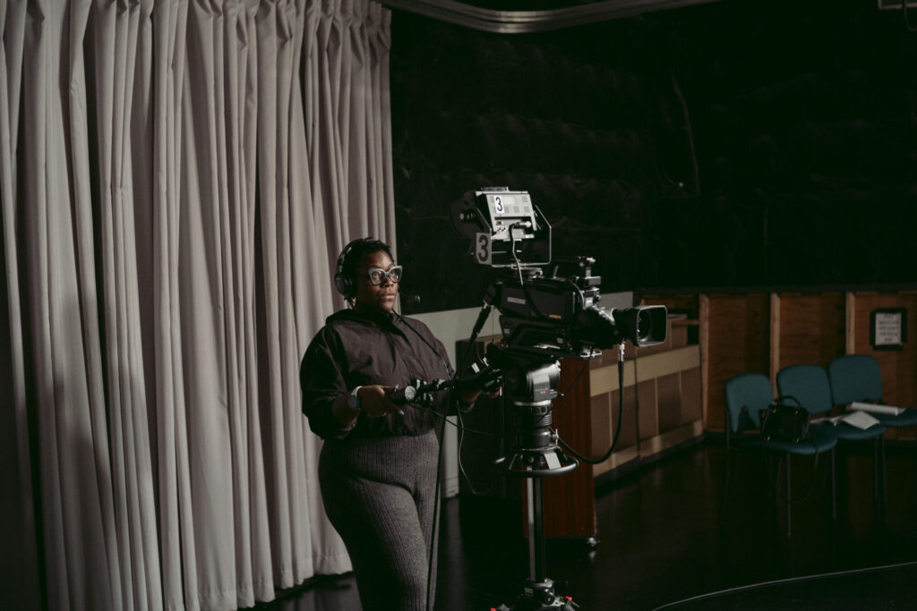 Ebenecia Twum-Baah runs a floor camera in the studio on the first night of her Basics class. Photo by Logan Cyrus