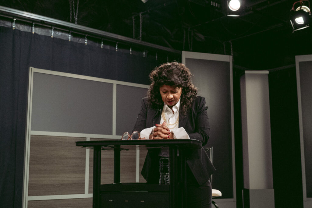 Shanita Poe leans over to pray before the start of her show. Photo by Logan Cyrus