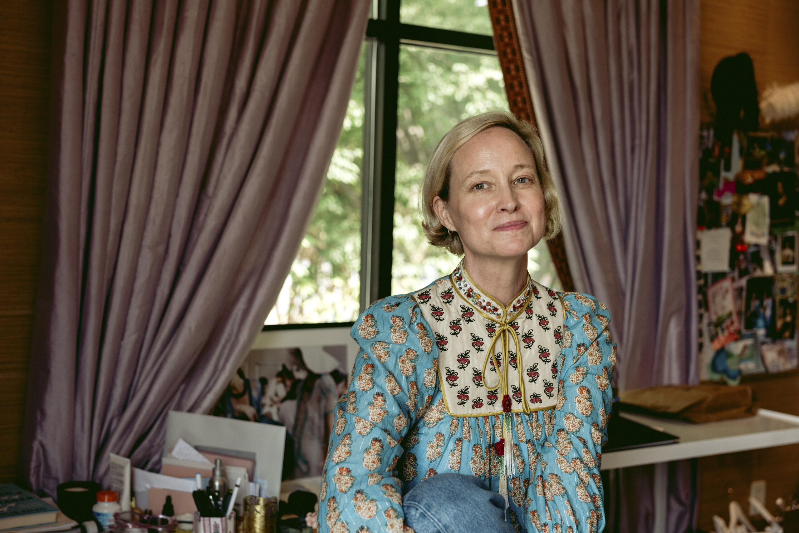 Laura Vinroot Poole sits on her desk in her office at Capitol