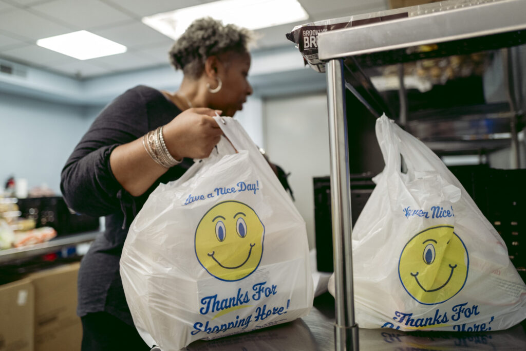 Volunteer Shara Jones packs bags at Hearts and Hands food pantry. Photo by Logan Cyrus