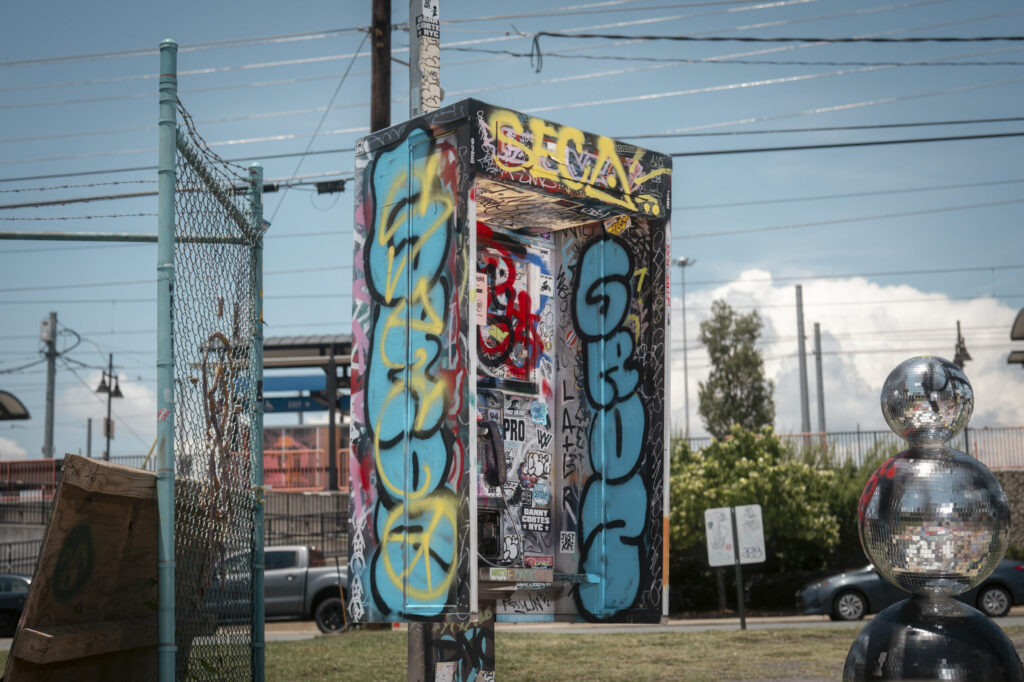 Standing Outside a Broken Phone Booth in Charlotte